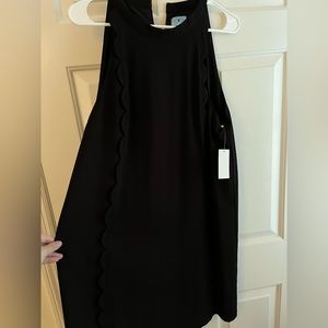 CeCe black sleeveless dress with scalloped overlay down the front. Never worn